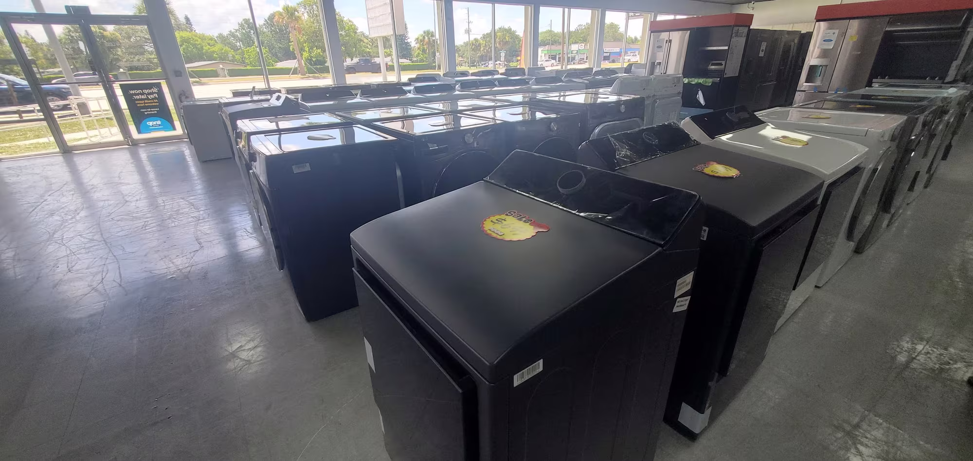 Top-load washers with sale tags on the showroom floor
